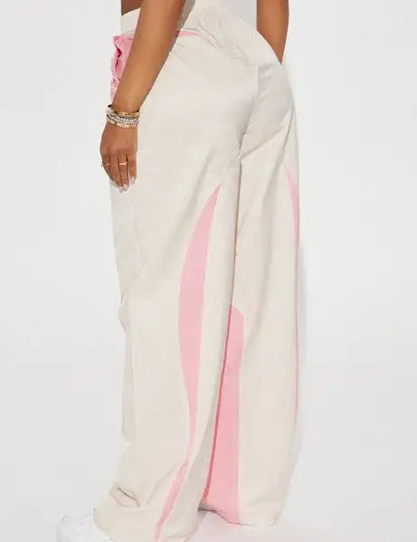 Beige wide-leg pants with pink wave panel detailing