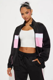 Black zip jacket and straight-leg pants set with pink panel